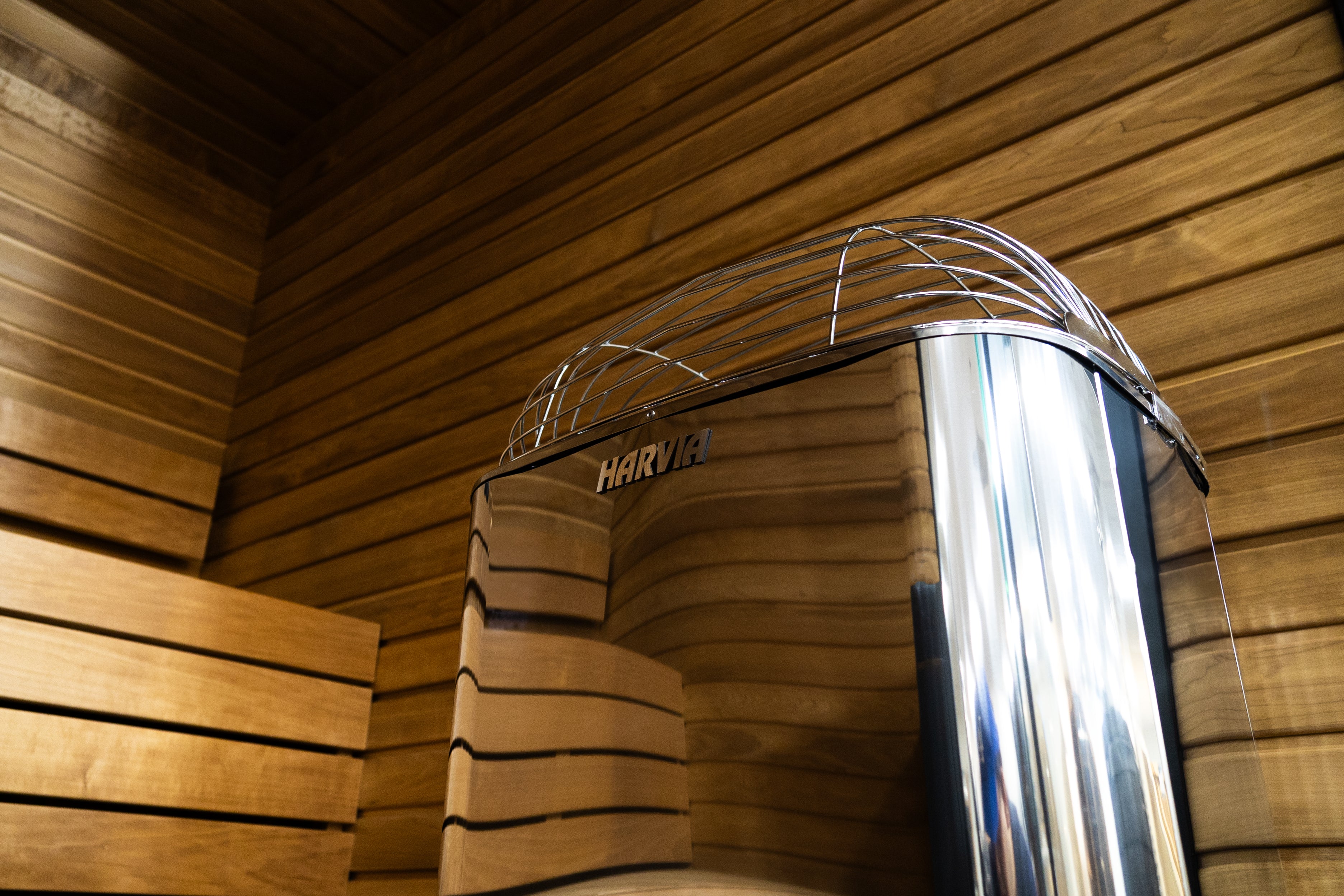 Harvia sauna with wooden walls and a metallic door. Heavy-Duty Power for Large Commercial or Luxury Saunas The Harvia Club Series is the ultimate choice when you need continuous performance for group saunas, wellness centers, gyms, hotels, or large residential sanctuaries.Built in Finland and engineered for all-day use, the Club delivers abundant, gentle steam from morning till night.