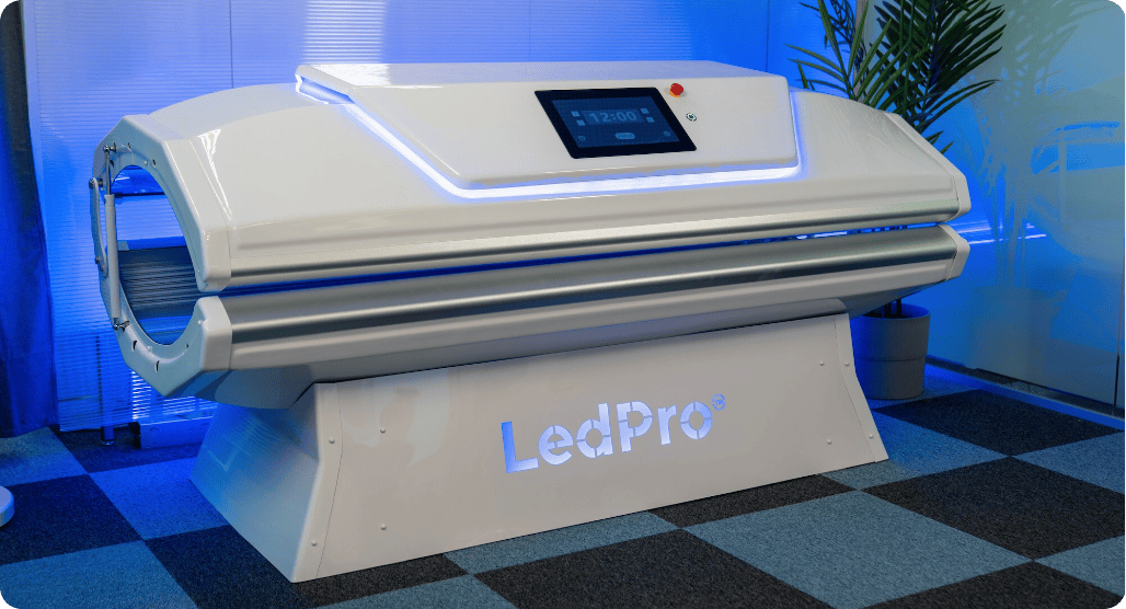 LedPro tanning bed on a checkered floor with blue lighting