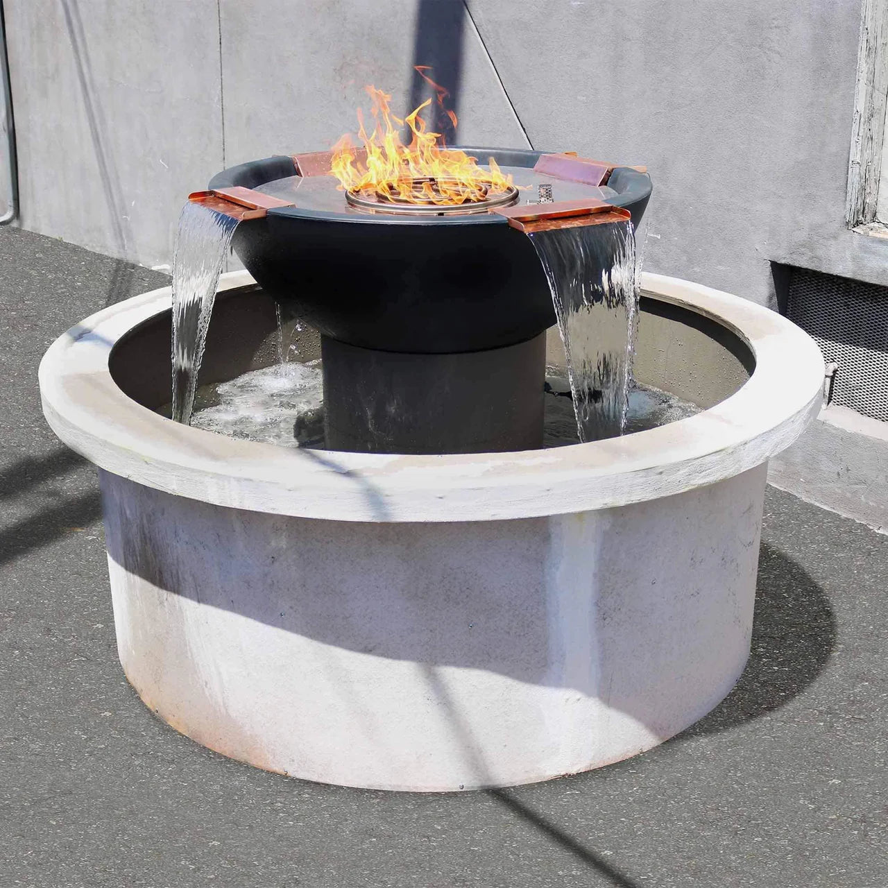  The Sedona GFRC Fire & Water Bowl – 4-Way Spill by The Outdoor Plus combines sculptural elegance with calming ambience. Crafted from durable Glass Fiber Reinforced Concrete (GFRC), it features a dramatic four-way waterfall and central fire bowl to create a mesmerizing fire‑and‑water experience. 